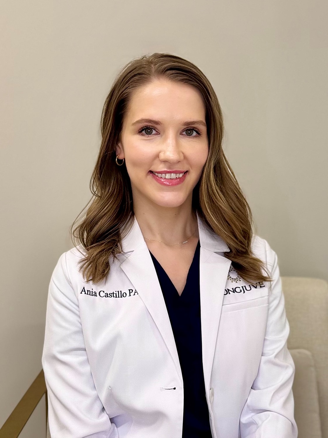 LongJuve's Ania Castillo PA-C smiling in white coat.