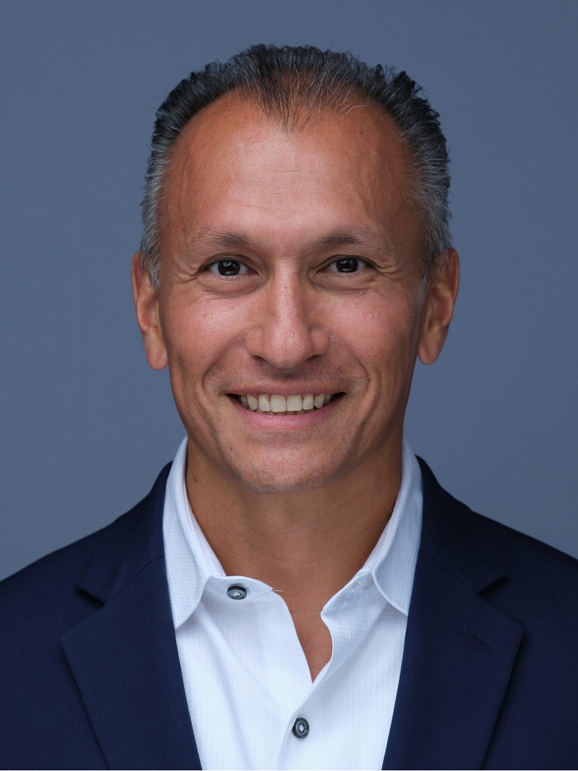 LongJuve's Dr. Fermin Barrueto smiling in blue suit. 