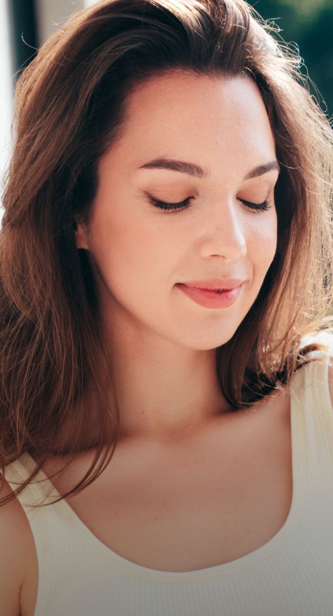 Woman with closed eyes, serene expression.
