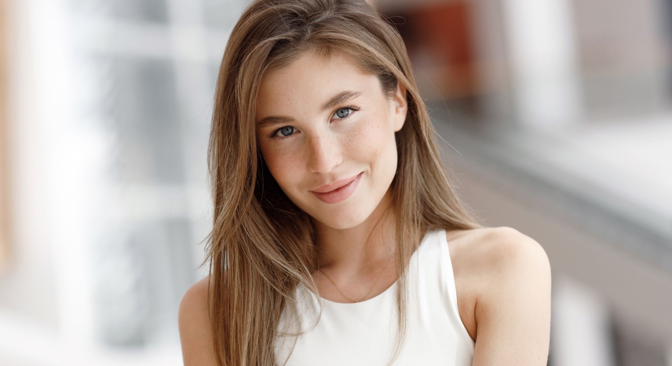 Smiling young woman with long brown hair.